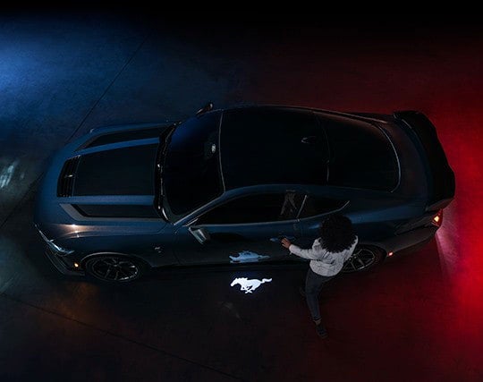 2024 Ford Mustang® Dark Horse™ model with a driver approaching the vehicle | Elmer Hare Ford Sales, Inc. in Marshall MO