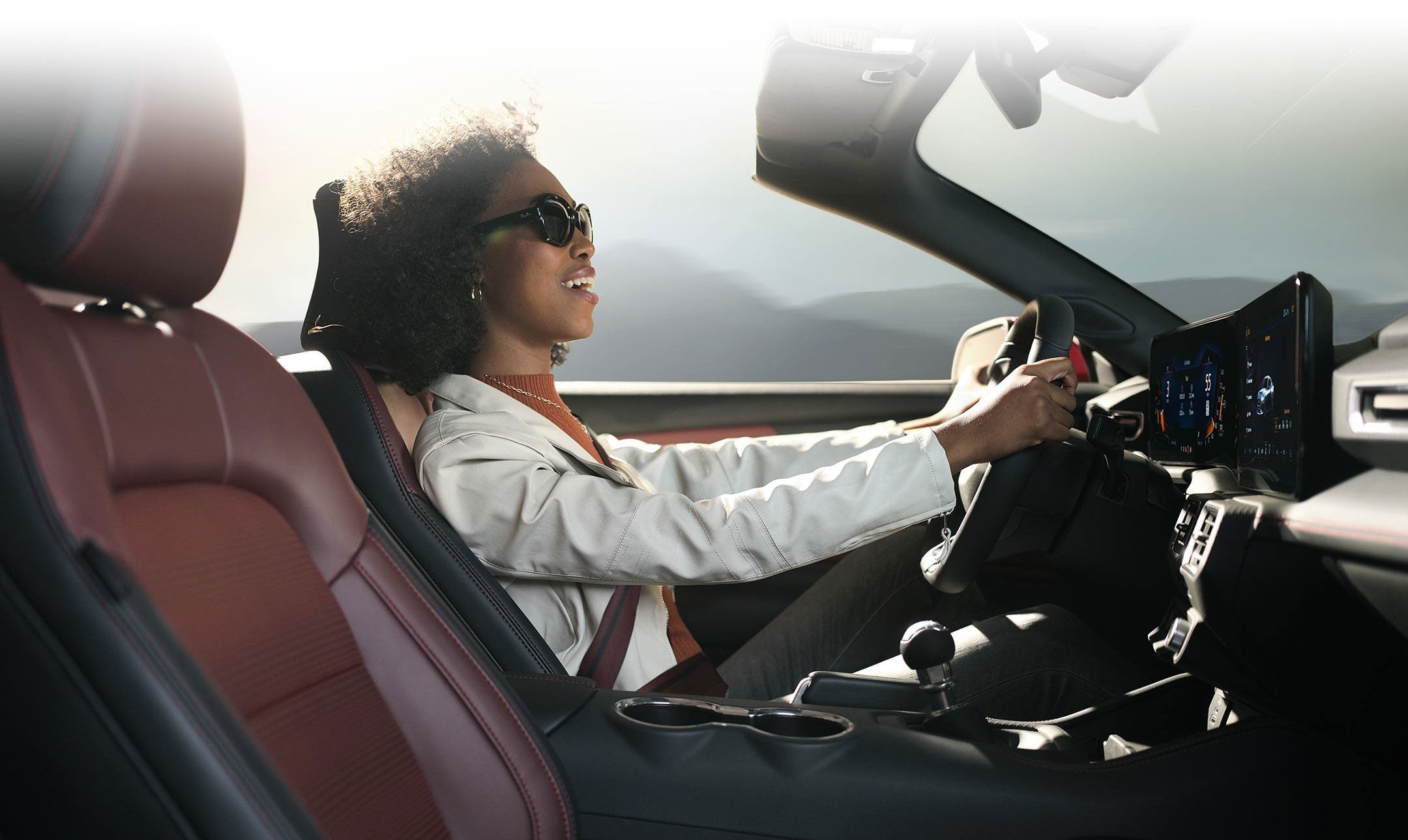 Person sitting in the driver’s seat of a 2024 Ford Mustang® convertible | Elmer Hare Ford Sales, Inc. in Marshall MO